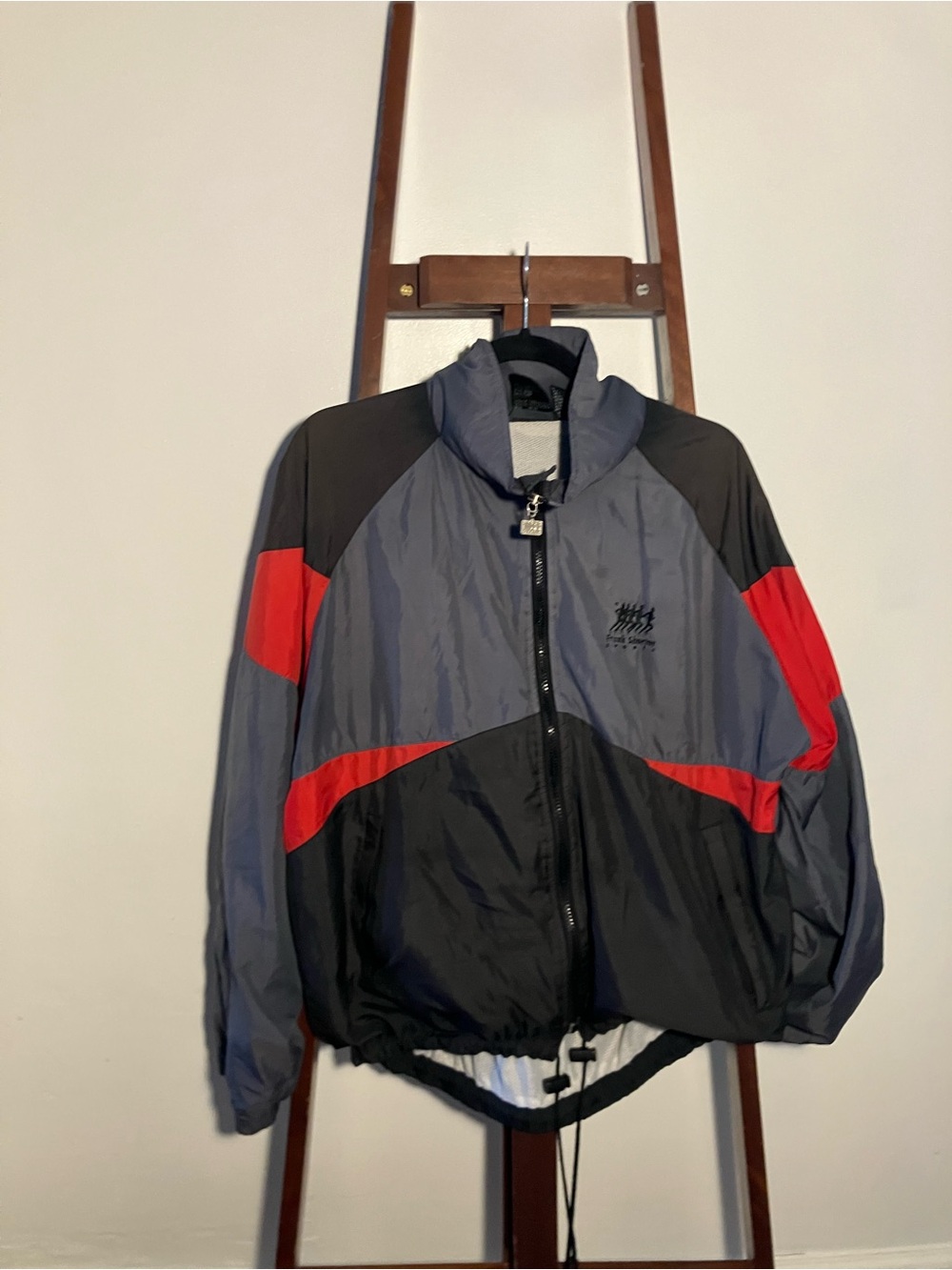 Vintage Frank Shorter sports windbreaker features a gray, black, and red